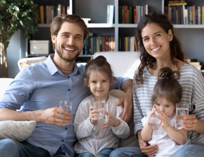 a family drinking a glass of water